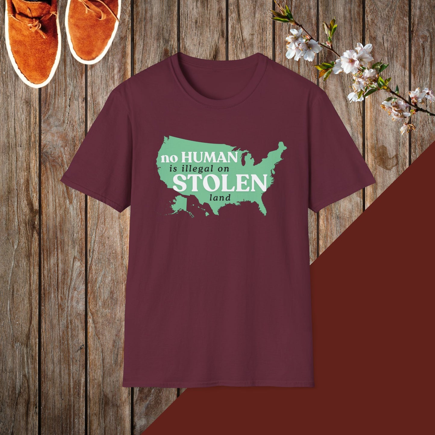 No Human is Illegal on Stolen Land Unisex Softstyle T-Shirt with 'No Human is Illegal on Stolen Land' Print