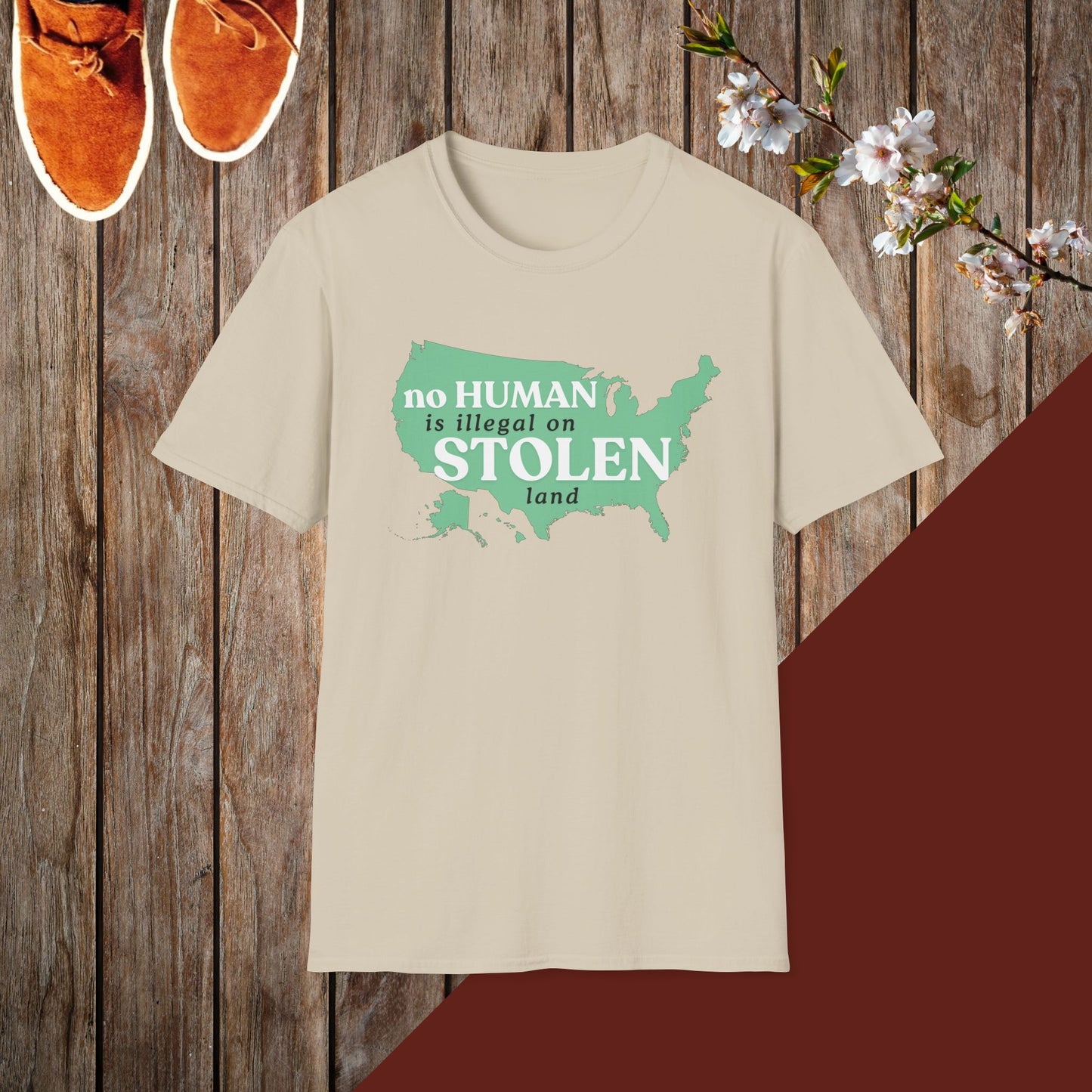 No Human is Illegal on Stolen Land Unisex Softstyle T-Shirt with 'No Human is Illegal on Stolen Land' Print