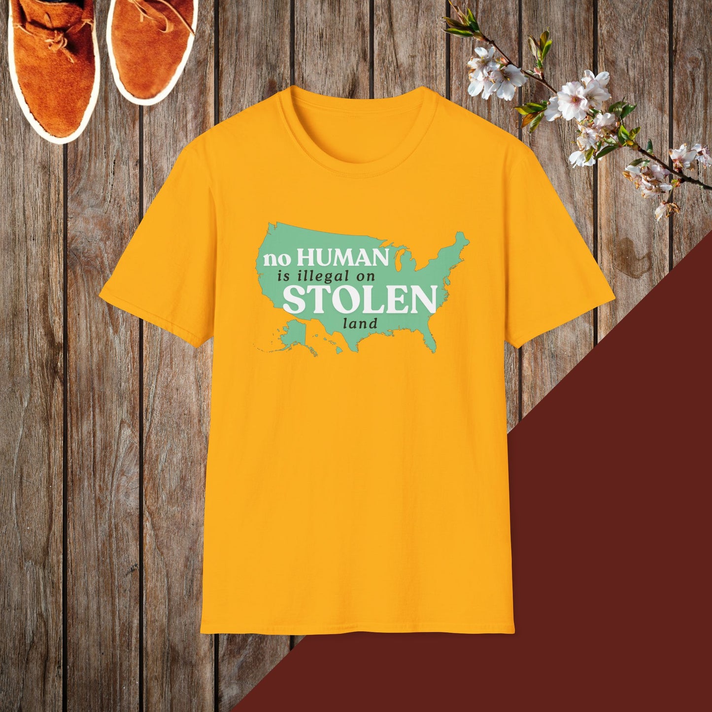 No Human is Illegal on Stolen Land Unisex Softstyle T-Shirt with 'No Human is Illegal on Stolen Land' Print