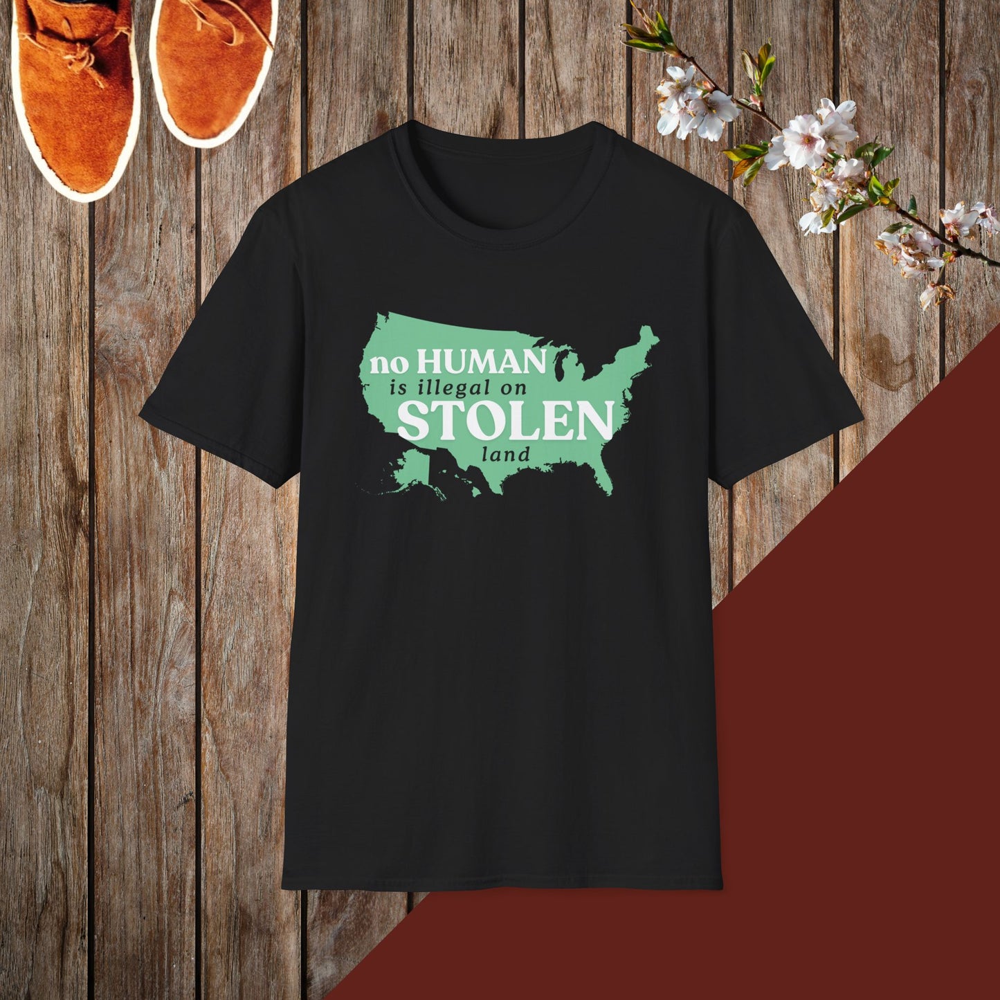 No Human is Illegal on Stolen Land Unisex Softstyle T-Shirt with 'No Human is Illegal on Stolen Land' Print