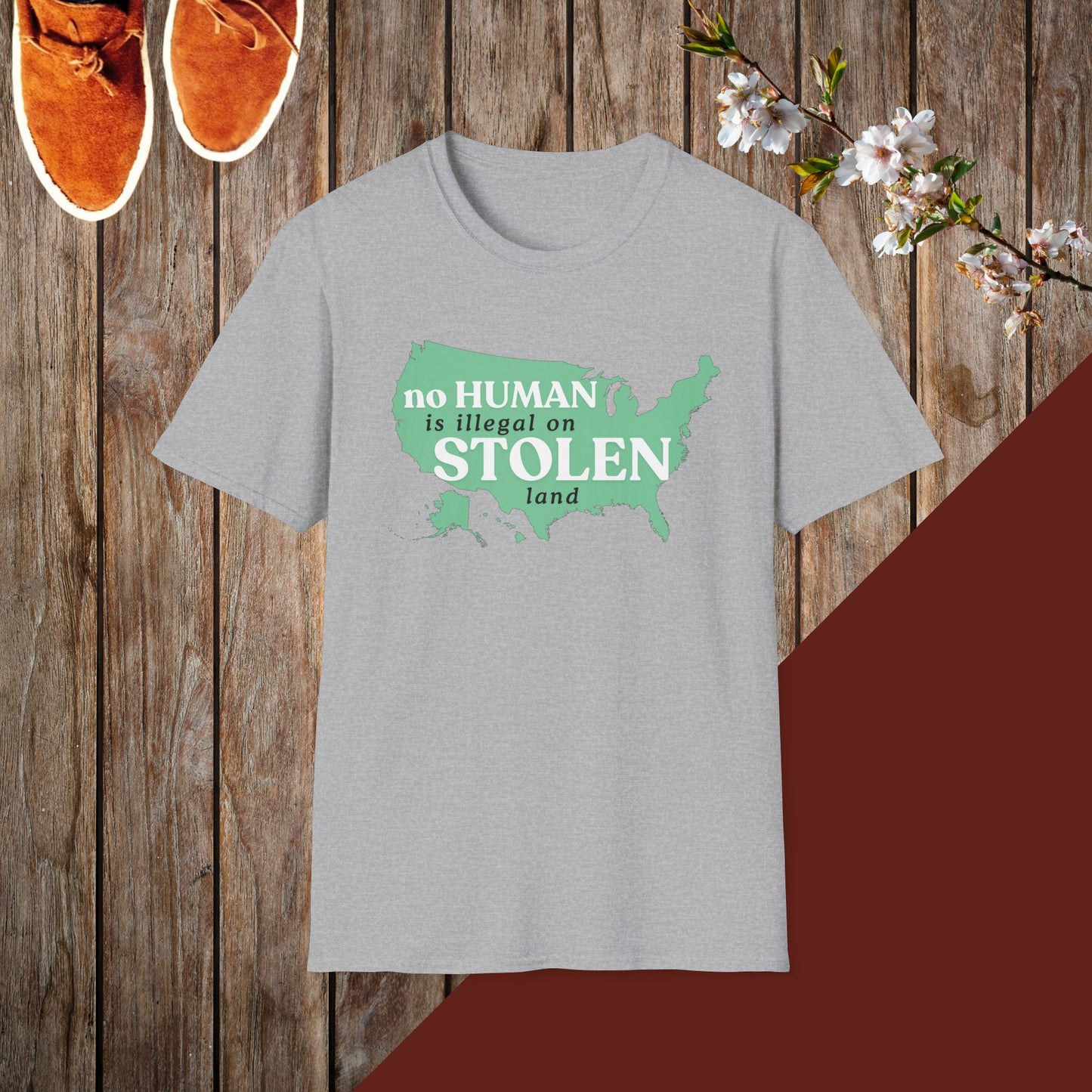No Human is Illegal on Stolen Land Unisex Softstyle T-Shirt with 'No Human is Illegal on Stolen Land' Print