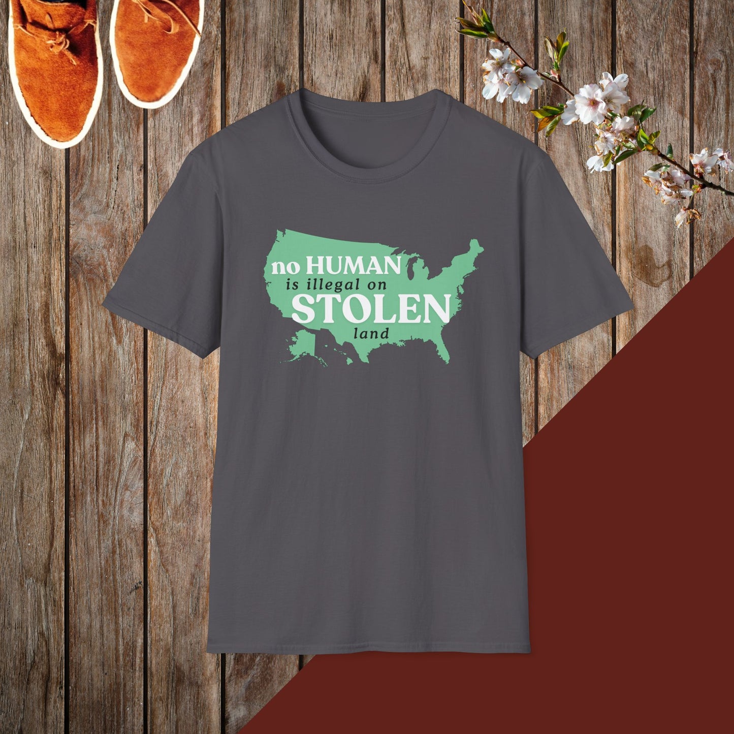 No Human is Illegal on Stolen Land Unisex Softstyle T-Shirt with 'No Human is Illegal on Stolen Land' Print